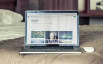 MacBook Pro on gray bed